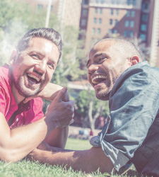 gay couple lying on the grass